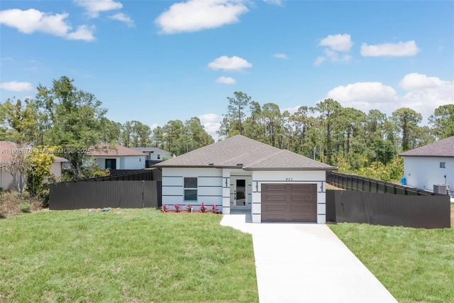 921 Winters St E, Lehigh Acres, FL 33974 - view of front of house with an attached garage, concrete driveway, central AC, stucco siding, and a shingled roof