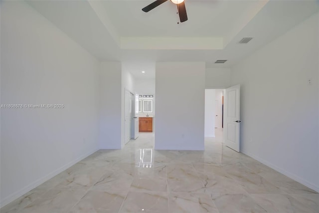 921 Winters St E, Lehigh Acres, FL 33974 - spare room with light marble finish floors, a ceiling fan, a tray ceiling, baseboards, and recessed lighting