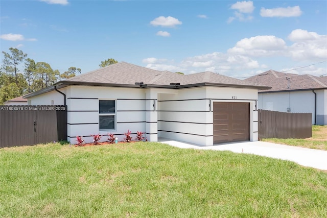 921 Winters St E, Lehigh Acres, FL 33974 - view of home's exterior with an attached garage, driveway, and stucco siding