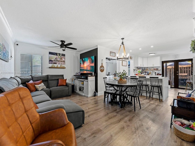12749 SW 71st Ter, Miami, FL 33183 - living area with ornamental molding, ceiling fan, light wood finished floors, a textured ceiling, and a chandelier