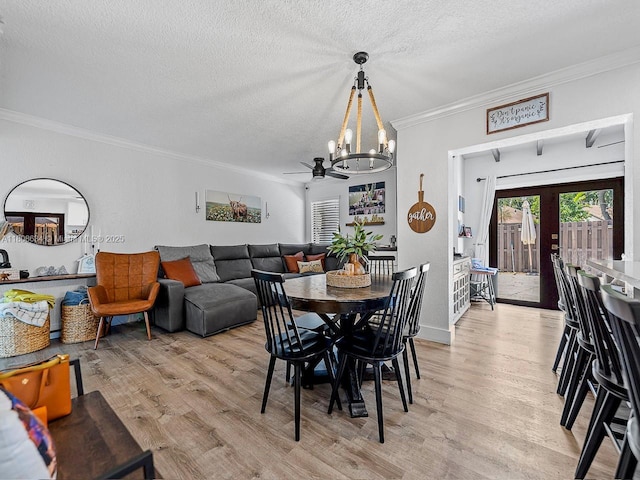 12749 SW 71st Ter, Miami, FL 33183 - dining space featuring a chandelier, light wood-type flooring, crown molding, a textured ceiling, and baseboards