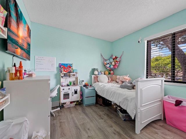 12749 SW 71st Ter, Miami, FL 33183 - bedroom with wood finished floors and a textured ceiling