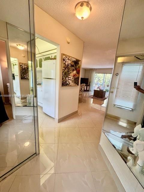 700 NE 14th Ave Unit 204, Hallandale Beach, FL 33009 - bathroom with a textured ceiling and baseboards