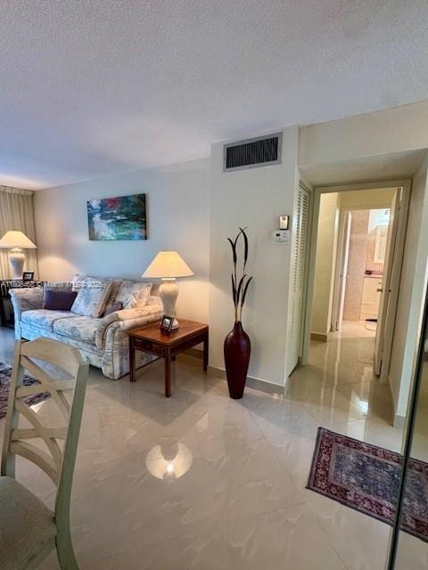 700 NE 14th Ave Unit 204, Hallandale Beach, FL 33009 - living room featuring a textured ceiling