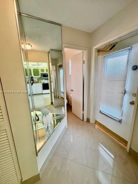 700 NE 14th Ave Unit 204, Hallandale Beach, FL 33009 - bathroom with marble look tiles and baseboards