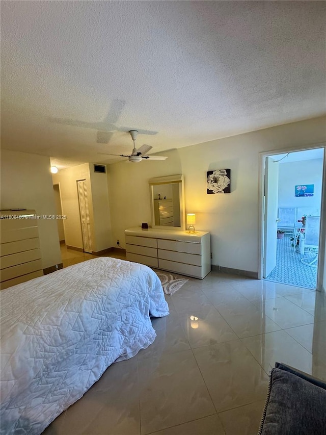700 NE 14th Ave Unit 204, Hallandale Beach, FL 33009 - bedroom featuring a textured ceiling, baseboards, and ceiling fan