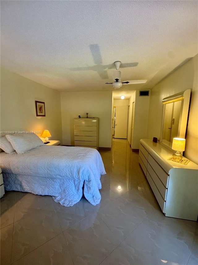 700 NE 14th Ave Unit 204, Hallandale Beach, FL 33009 - bedroom featuring a textured ceiling, ceiling fan, and marble finish flooring
