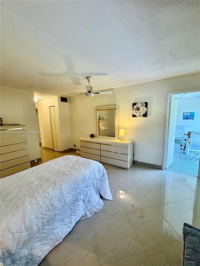 700 NE 14th Ave Unit 204, Hallandale Beach, FL 33009 - bedroom with a textured ceiling, baseboards, and a ceiling fan