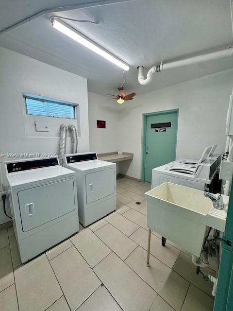 700 NE 14th Ave Unit 204, Hallandale Beach, FL 33009 - shared laundry room featuring washer and dryer, a ceiling fan, and light tile patterned flooring
