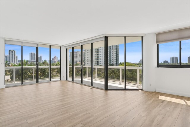 20185 E Country Club Dr Unit 505, Aventura, FL 33180 - empty room with a skyline view and light wood-style floors