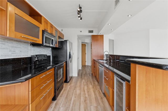 20185 E Country Club Dr Unit 505, Aventura, FL 33180 - kitchen featuring stainless steel appliances, beverage cooler, a sink, light wood finished floors, and brown cabinets