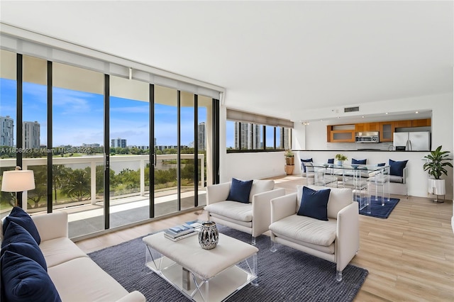 20185 E Country Club Dr Unit 505, Aventura, FL 33180 - living room with floor to ceiling windows, light wood-style floors, and a view of city