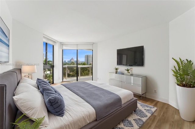 20185 E Country Club Dr Unit 505, Aventura, FL 33180 - bedroom with wood finished floors and baseboards