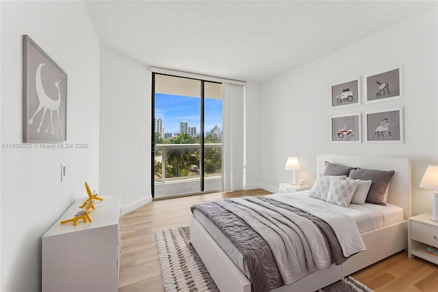 20185 E Country Club Dr Unit 505, Aventura, FL 33180 - bedroom featuring access to exterior, light wood-style flooring, and floor to ceiling windows