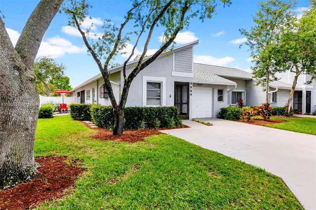 8886 Windtree St, Boca Raton, FL 33496 - mid-century inspired home with a garage, stucco siding, driveway, and roof with shingles