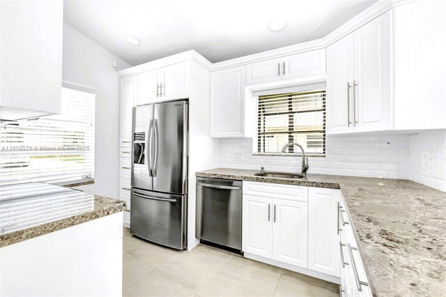 8886 Windtree St, Boca Raton, FL 33496 - kitchen with stainless steel appliances, a sink, white cabinetry, backsplash, and light tile patterned floors
