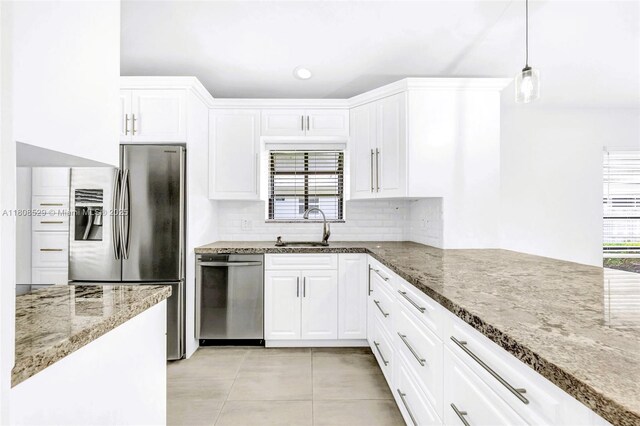 8886 Windtree St, Boca Raton, FL 33496 - kitchen with appliances with stainless steel finishes, light tile patterned flooring, stone counters, decorative backsplash, and white cabinetry