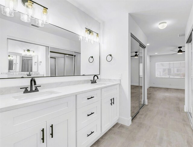 8886 Windtree St, Boca Raton, FL 33496 - full bathroom featuring a ceiling fan, double vanity, and baseboards