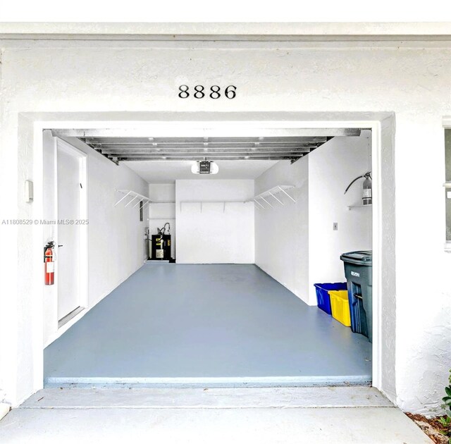 8886 Windtree St, Boca Raton, FL 33496 - garage featuring a garage door opener