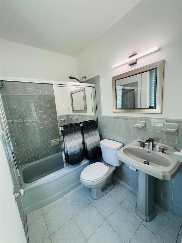 10178 Collins Ave Unit 210, Bal Harbour, FL 33154 - bathroom with tile walls, tile patterned flooring, a wainscoted wall, and shower / bathtub combination