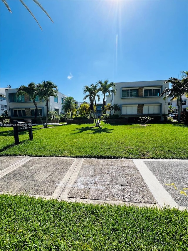 10178 Collins Ave Unit 210, Bal Harbour, FL 33154 - view of community with uncovered parking and a yard