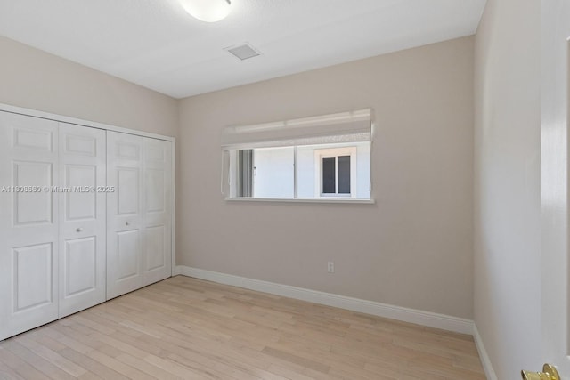 2922 Catalina St Unit 2922, Miami, FL 33133 - unfurnished bedroom featuring light wood-style flooring, baseboards, and a closet