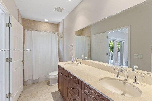 2922 Catalina St Unit 2922, Miami, FL 33133 - bathroom with double vanity, toilet, recessed lighting, and tile patterned flooring