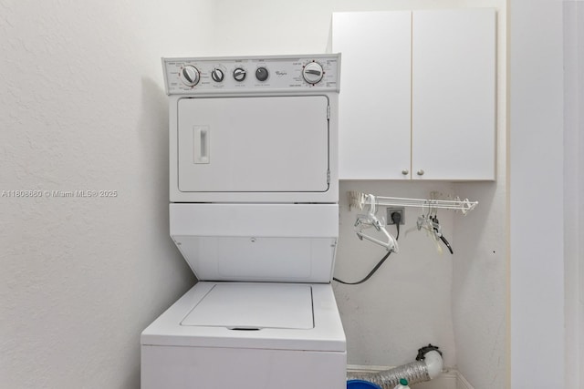 2922 Catalina St Unit 2922, Miami, FL 33133 - laundry room with stacked washer and clothes dryer, cabinet space, and a textured wall