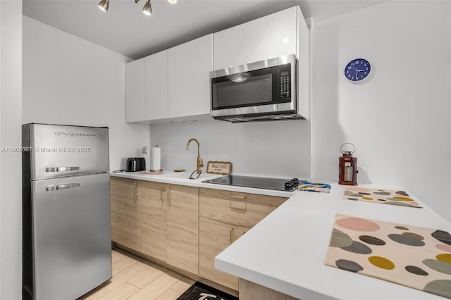 710 Washington Ave Unit 323, Miami Beach, FL 33139 - kitchen featuring stainless steel appliances, modern cabinets, and light countertops