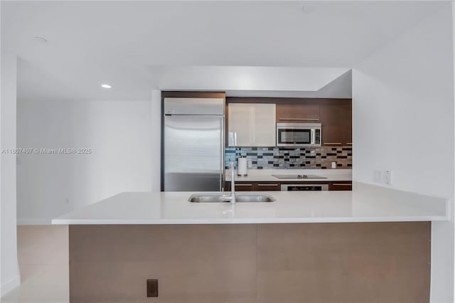 500 Brickell Ave Unit 3103, Miami, FL 33131 - kitchen featuring stainless steel appliances, a sink, light countertops, backsplash, and recessed lighting