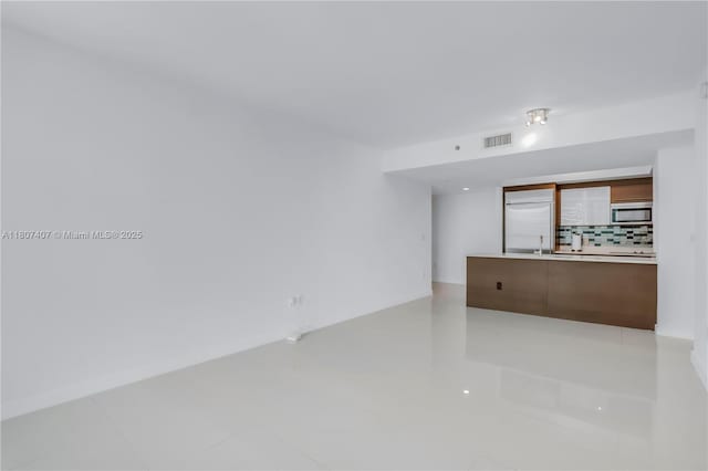 500 Brickell Ave Unit 3103, Miami, FL 33131 - unfurnished living room with light tile patterned floors and baseboards