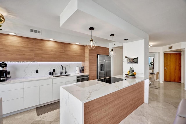 1000 W Island Blvd Unit 611, Aventura, FL 33160 - kitchen featuring stainless steel appliances, a sink, modern cabinets, backsplash, and decorative light fixtures