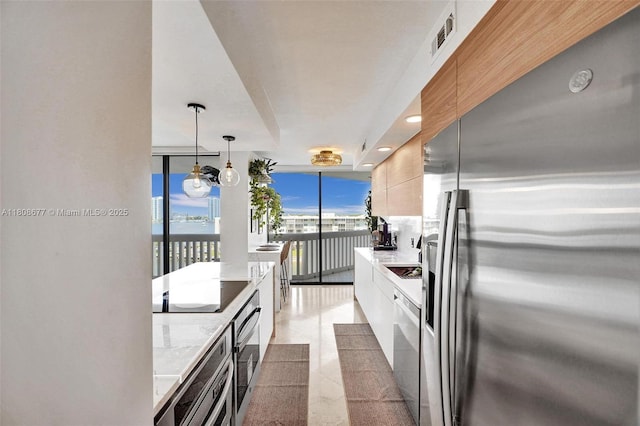 1000 W Island Blvd Unit 611, Aventura, FL 33160 - kitchen with stainless steel appliances, modern cabinets, light countertops, floor to ceiling windows, and white cabinets