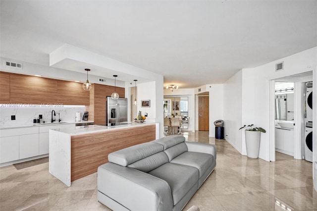 1000 W Island Blvd Unit 611, Aventura, FL 33160 - living area with estacked washer and dryer and light tile patterned floors