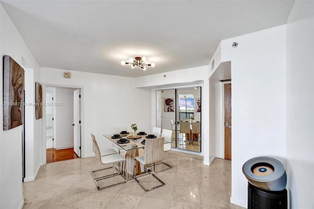1000 W Island Blvd Unit 611, Aventura, FL 33160 - dining room with a chandelier, baseboards, and light tile patterned floors