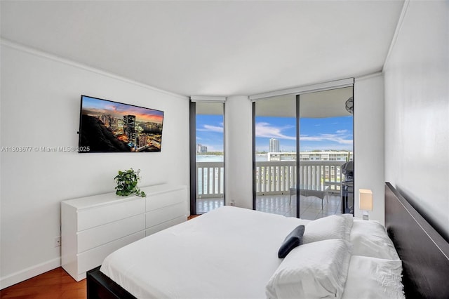 1000 W Island Blvd Unit 611, Aventura, FL 33160 - bedroom featuring access to exterior, wood finished floors, expansive windows, baseboards, and ornamental molding