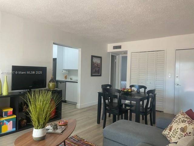 200 NW 107th Ave Unit 106, Miami, FL 33172 - living room with a textured ceiling and light wood-type flooring