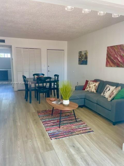 200 NW 107th Ave Unit 106, Miami, FL 33172 - living area with a textured ceiling and wood finished floors
