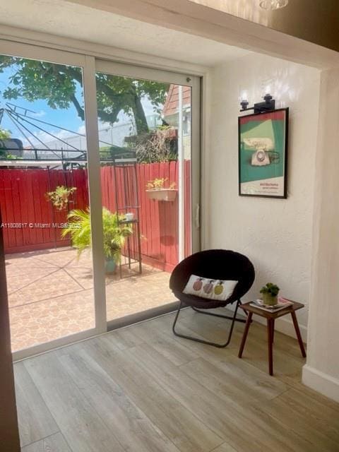 200 NW 107th Ave Unit 106, Miami, FL 33172 - doorway to outside with wood finished floors and baseboards