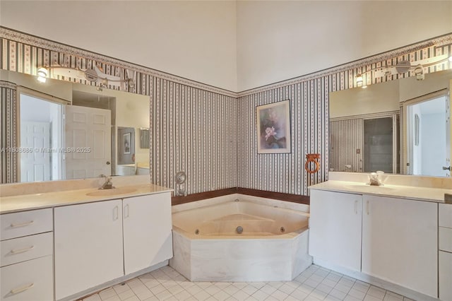8749 NW 189th Ter, Hialeah, FL 33018 - bathroom with two vanities, a tub with jets, and tile patterned floors