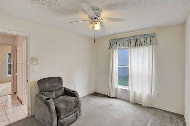 8749 NW 189th Ter, Hialeah, FL 33018 - sitting room with a ceiling fan, a textured ceiling, baseboards, and carpet floors