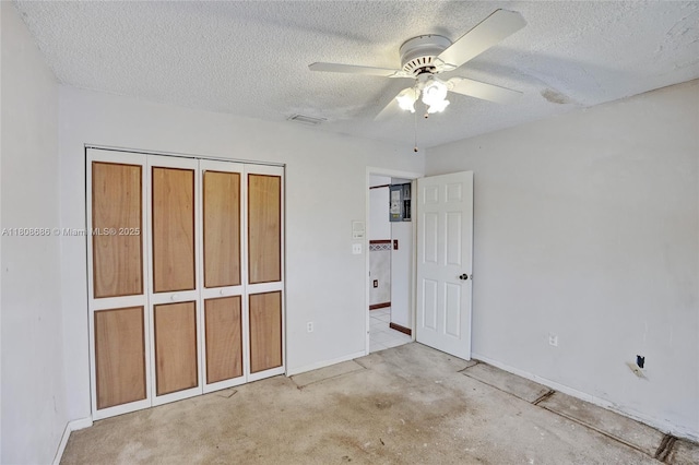 8749 NW 189th Ter, Hialeah, FL 33018 - unfurnished bedroom featuring a textured ceiling, baseboards, a ceiling fan, and a closet