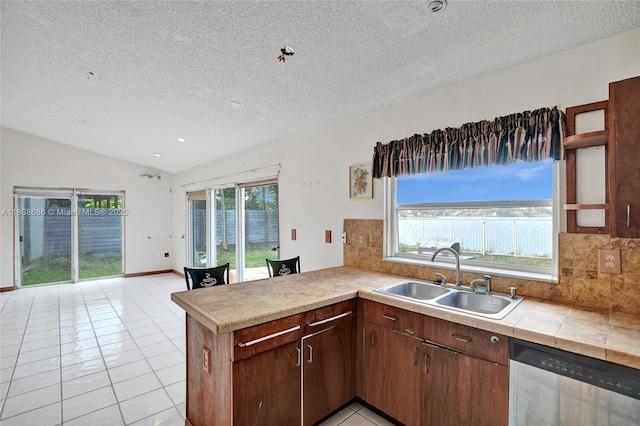 8749 NW 189th Ter, Hialeah, FL 33018 - kitchen featuring dishwasher, a sink, a textured ceiling, a peninsula, and tasteful backsplash