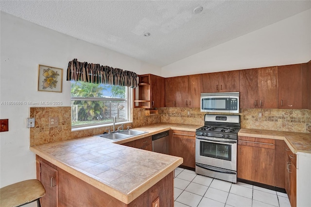 8749 NW 189th Ter, Hialeah, FL 33018 - kitchen with appliances with stainless steel finishes, a sink, a peninsula, tasteful backsplash, and a textured ceiling