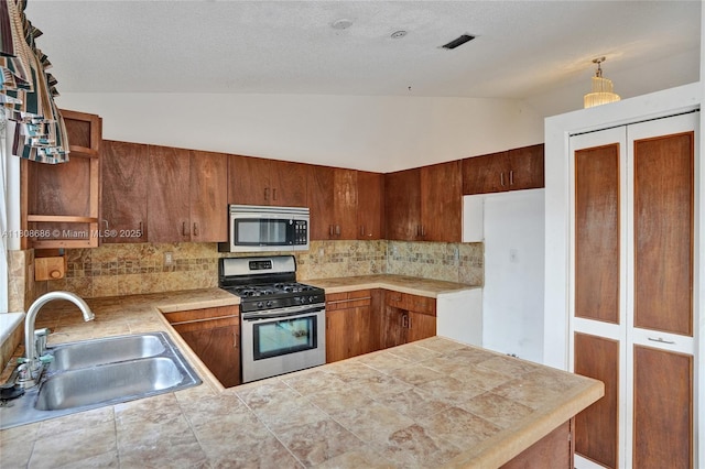 8749 NW 189th Ter, Hialeah, FL 33018 - kitchen with appliances with stainless steel finishes, a sink, lofted ceiling, backsplash, and open shelves