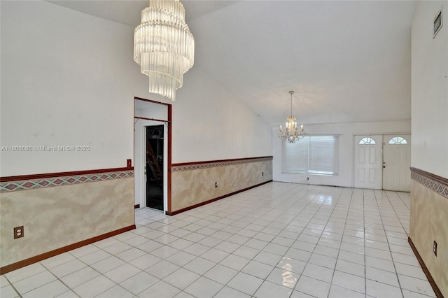 8749 NW 189th Ter, Hialeah, FL 33018 - tiled empty room featuring a chandelier, vaulted ceiling, and wainscoting