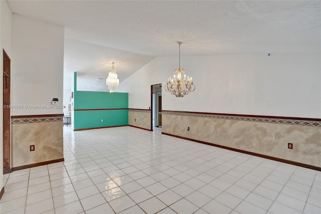 8749 NW 189th Ter, Hialeah, FL 33018 - spare room with a chandelier, wainscoting, vaulted ceiling, and light tile patterned flooring
