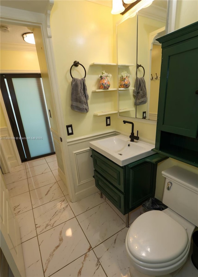 16401 SW 141st Ave, Miami, FL 33177 - bathroom with marble look tiles, vanity, toilet, crown molding, and a wainscoted wall
