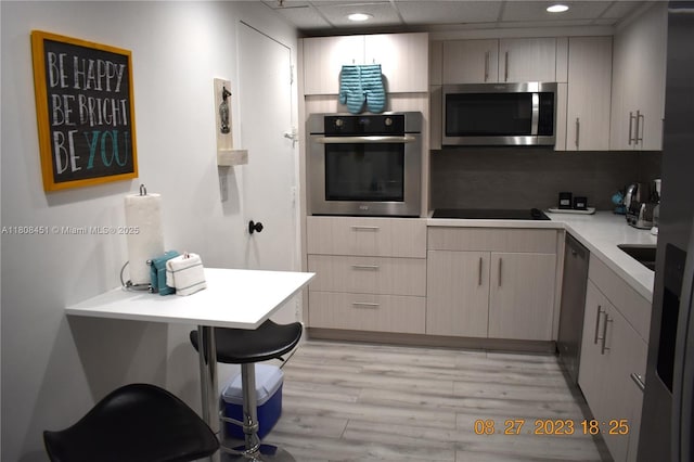 3901 S Ocean Dr Unit 11A, Hollywood, FL 33019 - kitchen featuring appliances with stainless steel finishes, light wood-style floors, light countertops, and recessed lighting