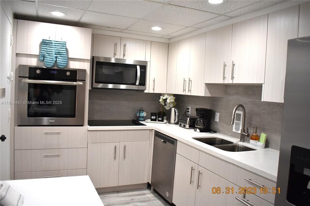 3901 S Ocean Dr Unit 11A, Hollywood, FL 33019 - kitchen with stainless steel appliances, a sink, light countertops, recessed lighting, and decorative backsplash